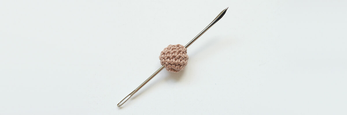 step-by-step instructions bead animal charm: making a hole through a crochet bead for a crochet bead body