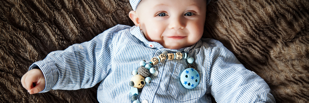 cute baby with dummy chain